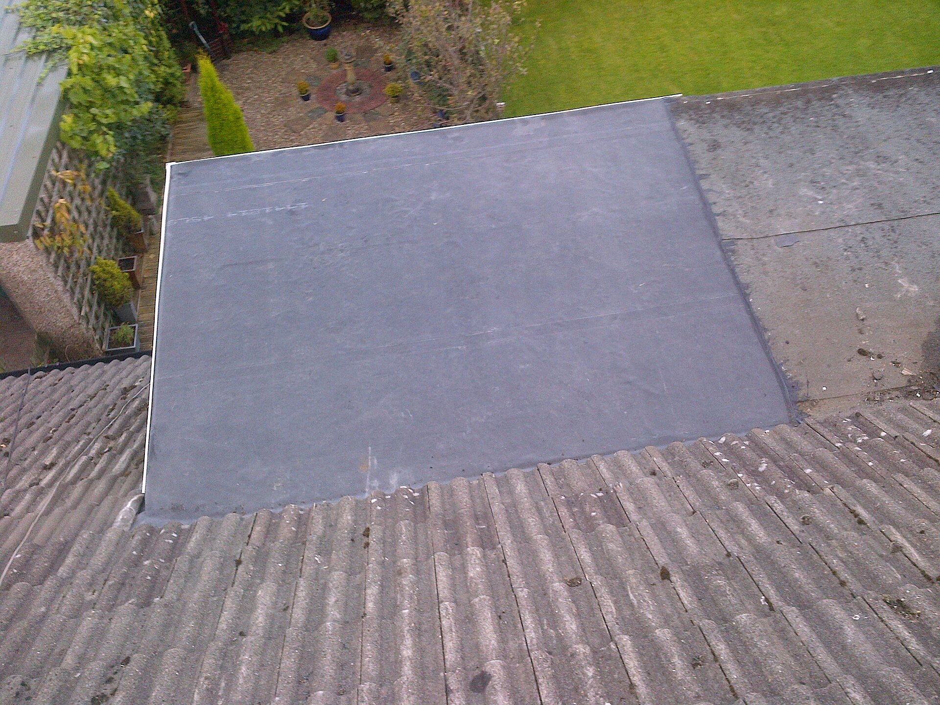 Finished rubber membrane roofing on a low-slope roof section