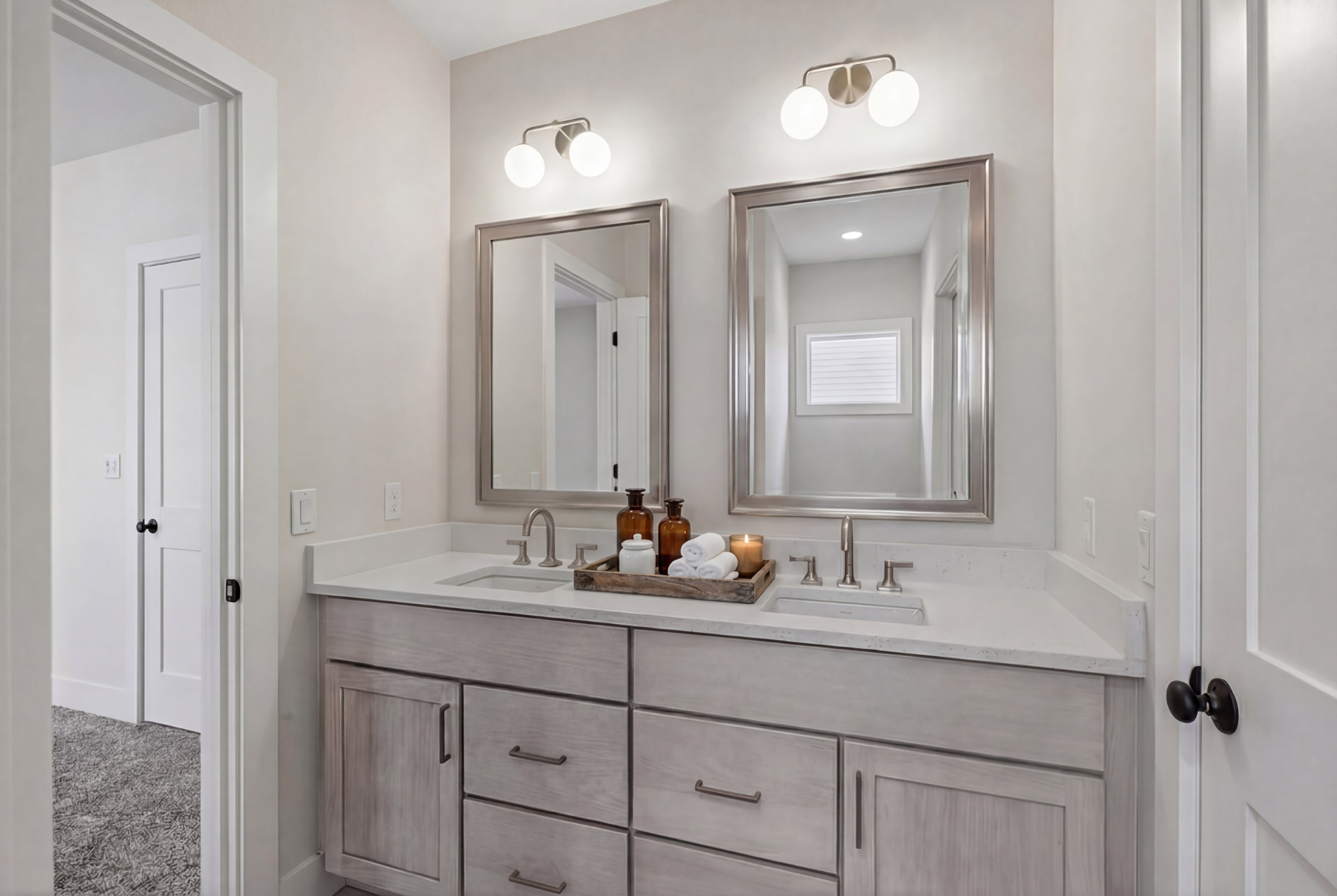 Guest bath with driftwood vanity, quartz counter, and framed mirrors