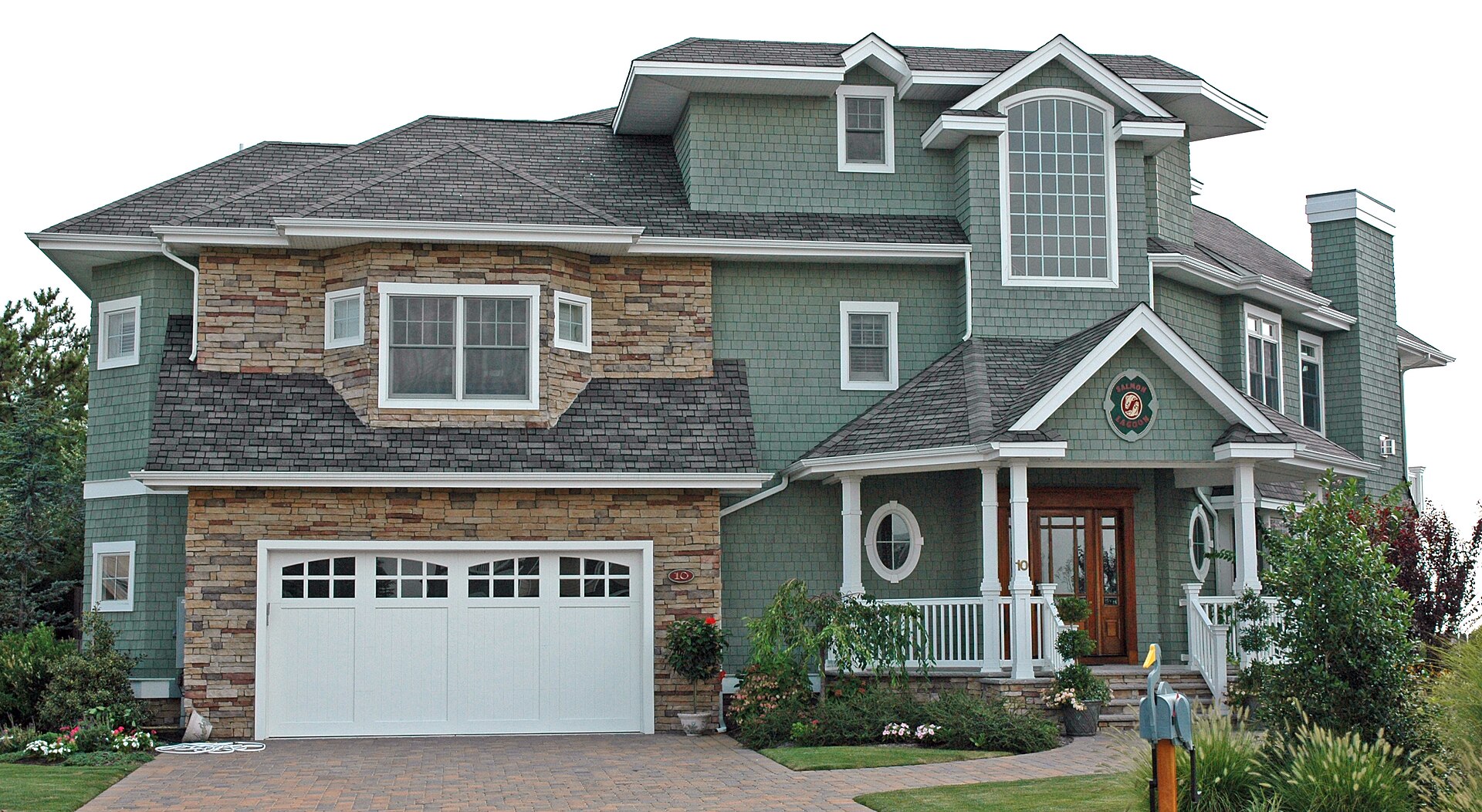 New England-style home finished with gray asphalt shingles